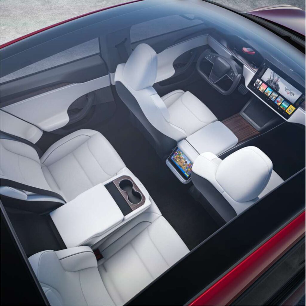 Aerial shot of the design refresh 2021 Tesla Model S showing the car's interior and all three screens.