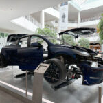 An exploded Tesla Model Y electric SUV on display at the Mall of America in Bloomington, Minnesota. The front driving unit (electric motor) is visible from this angle.