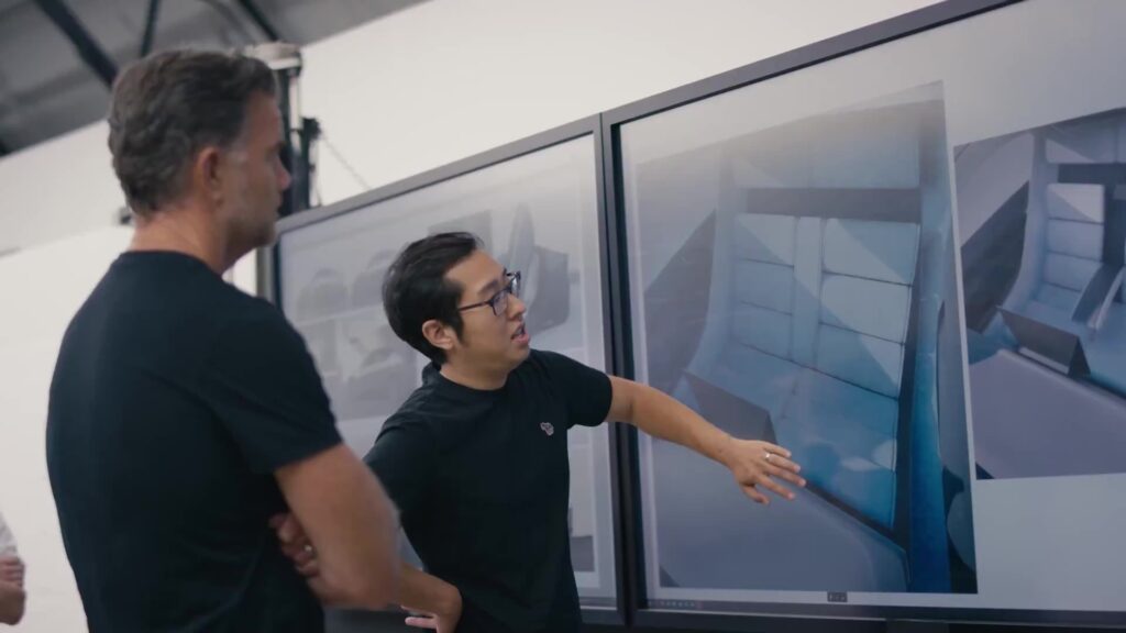 A Tesla Design team member giving Tesla Robotaxi interior briefing to the company’s Chief Designer Franz von Holzhausen. 