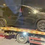 Tesla Model Y Juniper loaded on a vehicle transport trailer at Giga Shanghai. Front and rear ends are wrapped to hide the design refresh changes.