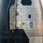 The nosecone of the Flight 6 Starship (Ship 31) painted with an interesting 'banana for scale' graphic meme.