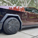 Tesla Cybertruck wrapped in Obsidian Red color by an owner from Florida (side profile view).