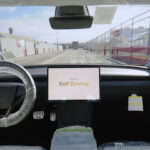 Self-Driving mode shows on the screen of a Tesla Model Y driving itself from the production line at Giga Texas to the outbound lot for shipment.